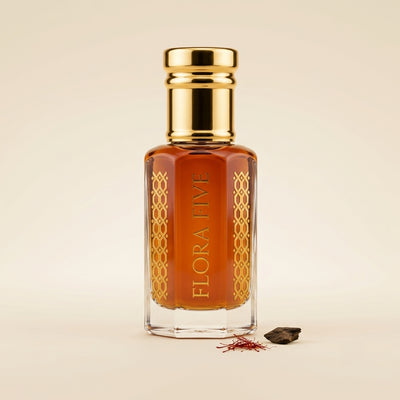 Aatish Oud by Flora Five — gold-capped bottle of deep amber oil with saffron threads and an oud chip on cream – 3, 6 and 12 ml