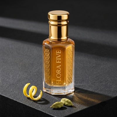 Azzaro The Most Wanted inspired attar for men by Flora Five — alcohol-free perfume oil: gold-capped bottle of golden amber oil on black stone with lemon peel and cardamom – 3, 6 and 12 ml