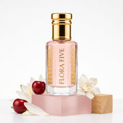 Bath & Body Works Pink Chiffon inspired attar for women — alcohol-free perfume oil by Flora Five: pale pink oil on a pink block with cherries and gardenias