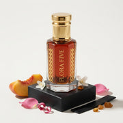 Burberry Black inspired attar for women — alcohol-free perfume oil by Flora Five: red-amber oil on a black block with peach, rose petals, jasmine and amber