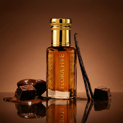 Chocolate Attar by Flora Five — gold-capped bottle of amber oil on brown with melted chocolate pieces and a vanilla pod – 3, 6 and 12 ml