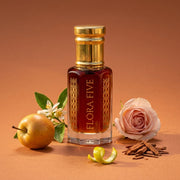 Dunhill Desire inspired attar for men — alcohol-free perfume oil by Flora Five: deep red-amber oil on orange with an apple, a rose and orange blossom