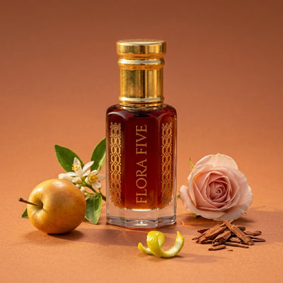 Dunhill Desire inspired attar for men by Flora Five — alcohol-free perfume oil: gold-capped bottle of deep red-amber oil on orange with an apple, a rose and orange blossom – 3, 6 and 12 ml