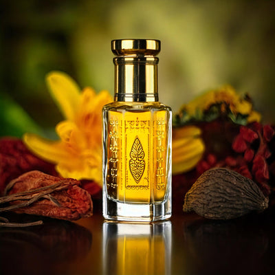 Tom Ford Noir de Noir inspired unisex attar by Flora Five — alcohol-free perfume oil: golden oil in a bottle with a medallion print among yellow lilies, red berries and spices – 3, 6 and 12 ml