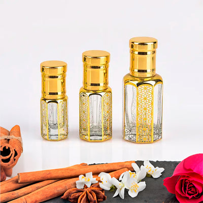 Kashmiri Oud by Flora Five — three empty gold-capped bottles of different heights with cinnamon sticks, star anise and white flowers – 3, 6 and 12 ml