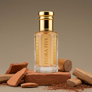 Mitti Attar, unisex — alcohol-free perfume oil by Flora Five: pale peach oil on a terracotta brick with clay shards, red earth and sandalwood logs