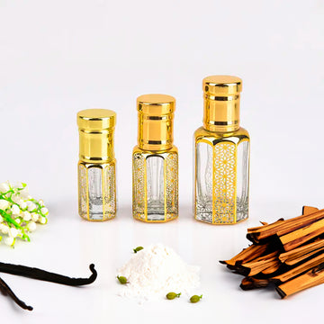 Musk Rizali Attar, unisex — alcohol-free perfume oil by Flora Five: three empty gold-capped bottles with vanilla pods, white powder and dry wood sticks
