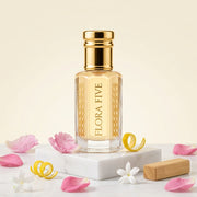 The Floral Bouquet Attar for women — alcohol-free attar oil by Flora Five: pale gold oil on marble with rose petals, jasmine, lemon peel and a wood block