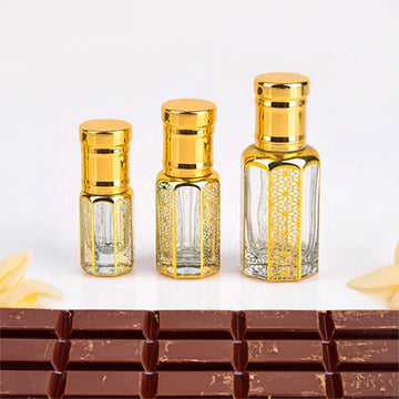 Choco Musk Attar, unisex — alcohol-free perfume oil by Flora Five: three empty gold-capped bottles in three sizes in front of a chocolate bar