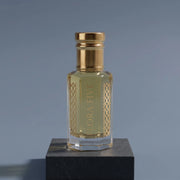 Dior Sauvage inspired attar for men — alcohol-free perfume oil by Flora Five: pale golden oil on a graphite block against a slate-blue backdrop