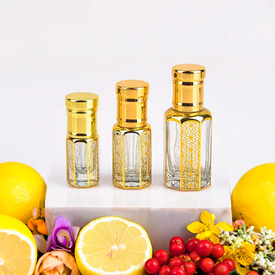 Gucci Guilty inspired attar for women by Flora Five — alcohol-free perfume oil: three empty gold-capped bottles of different heights with lemons, red berries and flowers – 3, 6 and 12 ml