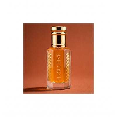 Oud Saffron unisex — alcohol-free oud oil (oudh) by Flora Five: amber oil bottle against a terracotta studio backdrop