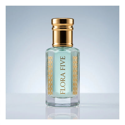 Rasasi Hawas inspired attar for men — alcohol-free attar oil by Flora Five: pale aqua oil in a gold-capped bottle on a soft blue-grey backdrop