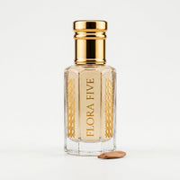 Amber Musk Attar by Flora Five — gold-capped bottle of pale cream oil with a wood chip on white – 3, 6 and 12 ml