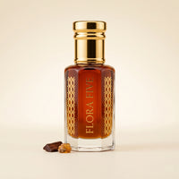 Amberwood Noir Attar by Flora Five — gold-capped bottle of deep amber oil with oud chips and amber resin on cream – 3, 6 and 12 ml