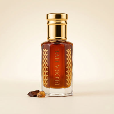 Amberwood Noir Attar by Flora Five — gold-capped bottle of deep amber oil with oud chips and amber resin on cream – 3, 6 and 12 ml
