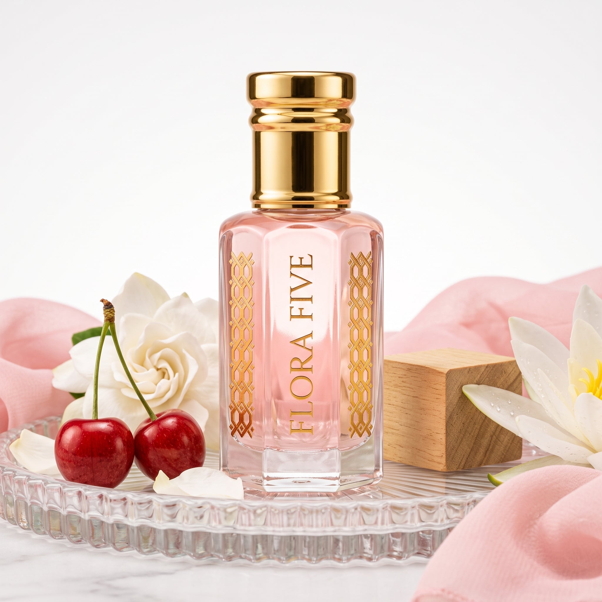 Bath & Body Works Pink Chiffon Inspired Attar by Flora Five — gold-capped bottle of pale pink oil on a glass tray with cherries, gardenia and pink silk – 3, 6 and 12 ml