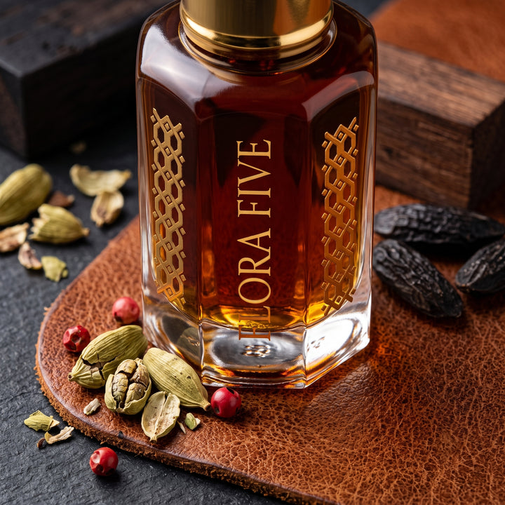 Bentley For Men Intense Inspired Attar by Flora Five — close-up of a gold-capped bottle of deep amber oil on leather with cardamom, tonka beans and pink peppercorns – 3, 6 and 12 ml