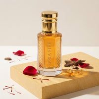 Ahmed Al Maghribi Bin Sheikh inspired unisex oud by Flora Five — alcohol-free oudh oil: gold-capped bottle of golden amber oil on a sandstone block with rose petals, oud chips and saffron – 3, 6 and 12 ml