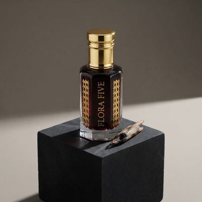 Nasomatto Black Afghano inspired unisex attar by Flora Five — alcohol-free perfume oil: gold-capped bottle of near-black oil on a black block with an oud chip – 3, 6 and 12 ml