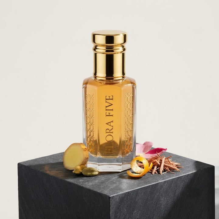 Burberry Brit for Men Inspired Attar by Flora Five — gold-capped bottle of golden yellow oil on a black block with ginger, mandarin peel and rose – 3, 6 and 12 ml