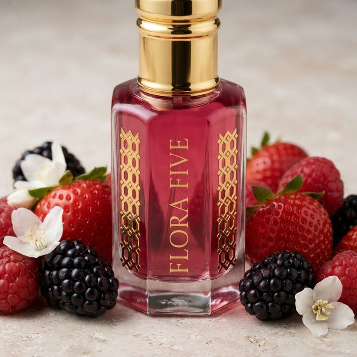 Burberry Her Inspired Attar by Flora Five — close-up of a gold-capped bottle of raspberry-pink oil with strawberries, blackberries and jasmine – 3, 6 and 12 ml