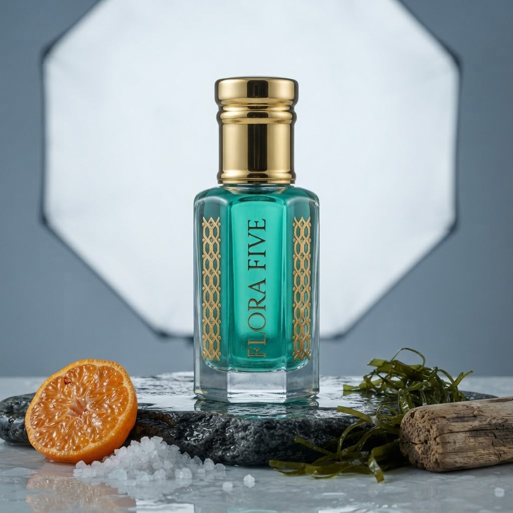 Bvlgari Aqva Inspired Attar by Flora Five — gold-capped bottle of teal oil on wet stone with a mandarin, sea salt and seaweed – 3, 6 and 12 ml