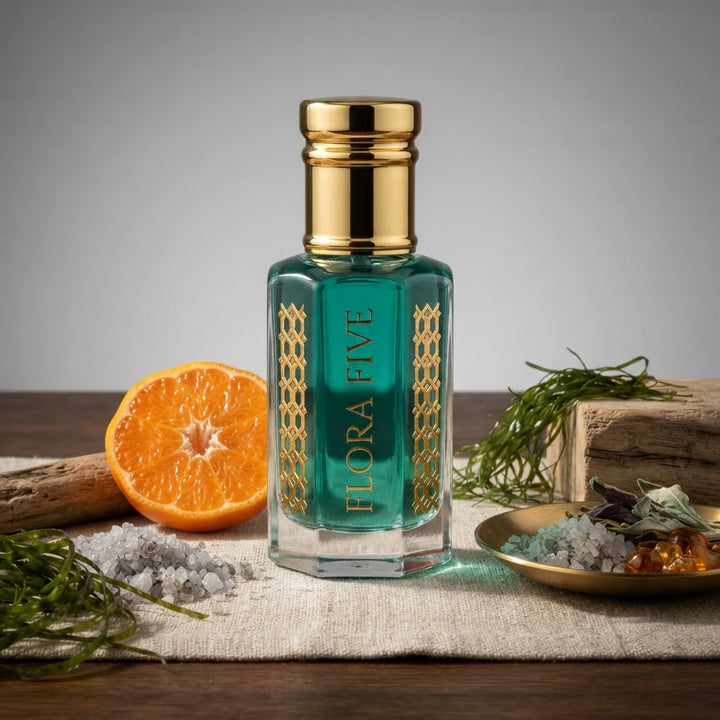 Bvlgari Aqva Inspired Attar by Flora Five — gold-capped bottle of teal oil on dark wood with a mandarin, sea salt and seaweed – 3, 6 and 12 ml