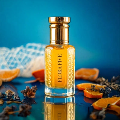 CR7 Blue inspired attar for men by Flora Five — alcohol-free perfume oil: gold-capped bottle of golden oil on blue with dried orange slices, cloves and netting – 3, 6 and 12 ml