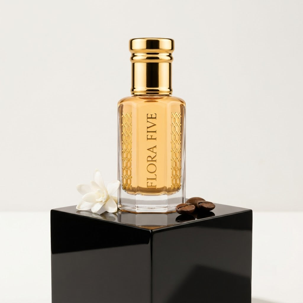 Carolina Herrera Good Girl Inspired Attar by Flora Five — gold-capped bottle of pale golden oil on a black plinth with a white flower and coffee beans – 3, 6 and 12 ml