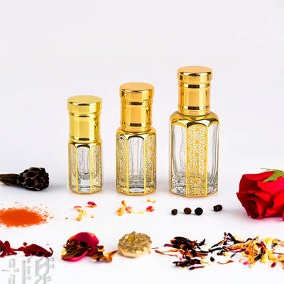 Mukhallat Emirates Attar by Flora Five — three empty gold-capped bottles of different heights with a red rose, cloves and chilli powder – 3, 6 and 12 ml