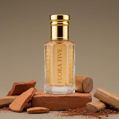 Mitti Attar by Flora Five — gold-capped bottle of pale peach oil on a terracotta brick with clay shards and sandalwood – 3, 6 and 12 ml