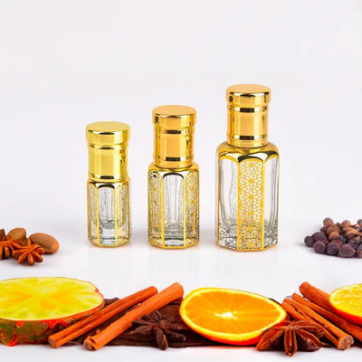Mukhallat Bahrain Attar by Flora Five — three empty gold-capped bottles of different heights with orange slices, cinnamon and star anise – 12 ml