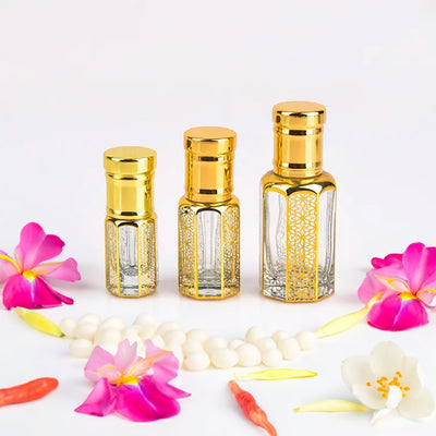 Chanel Chance inspired attar for women by Flora Five — alcohol-free perfume oil: three empty clear bottles of different heights with gold caps and lattice print, with pink orchids and pearls – 3, 6 and 12 ml