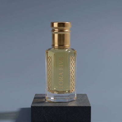 Dior Sauvage inspired attar for men — alcohol-free perfume oil by Flora Five: pale golden oil on a graphite block against a slate-blue backdrop