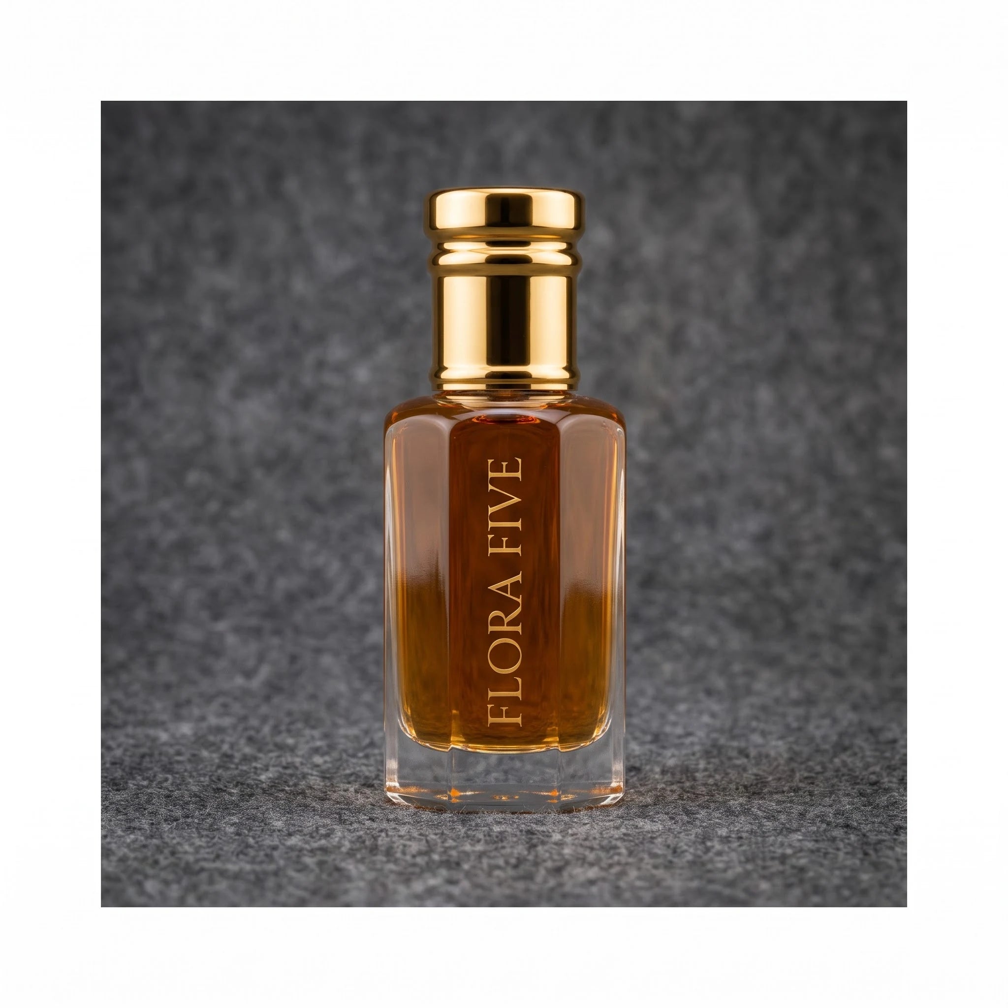 Dunhill Black inspired attar for men — alcohol-free perfume oil by Flora Five: amber oil in a gold-capped bottle against a charcoal felt backdrop