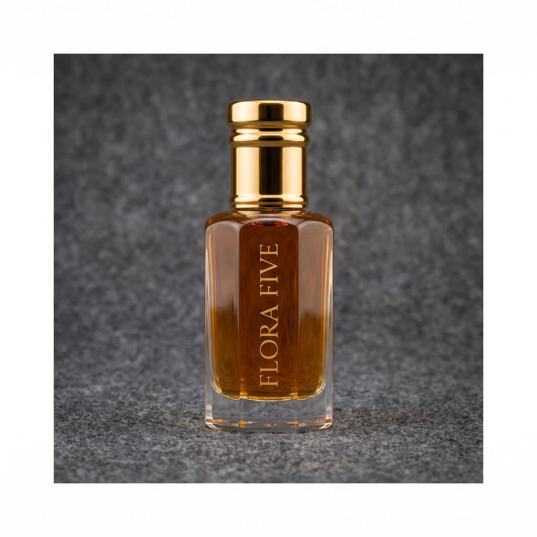Dunhill Black inspired attar for men — alcohol-free perfume oil by Flora Five: amber oil in a gold-capped bottle against a charcoal felt backdrop