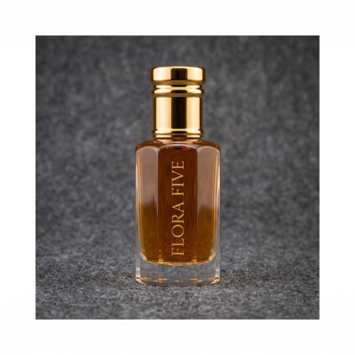 Dunhill Black inspired attar for men — alcohol-free perfume oil by Flora Five: amber oil in a gold-capped bottle against a charcoal felt backdrop