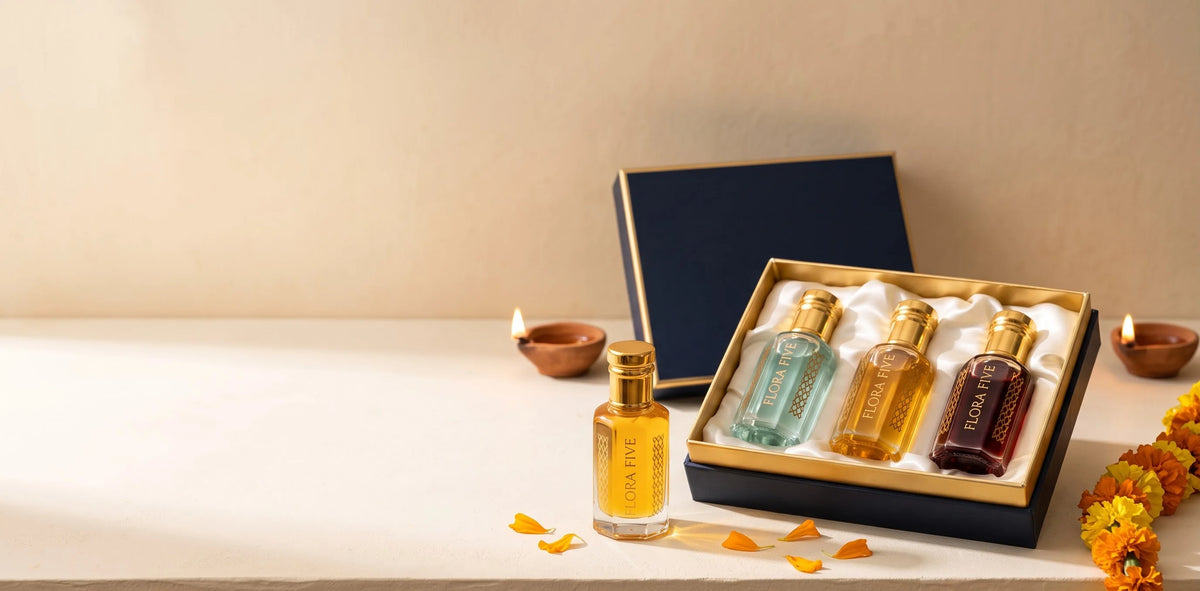 Flora Five Diwali gift box of three alcohol-free attars and ouds in aqua, saffron and garnet oils, with clay diyas and marigolds