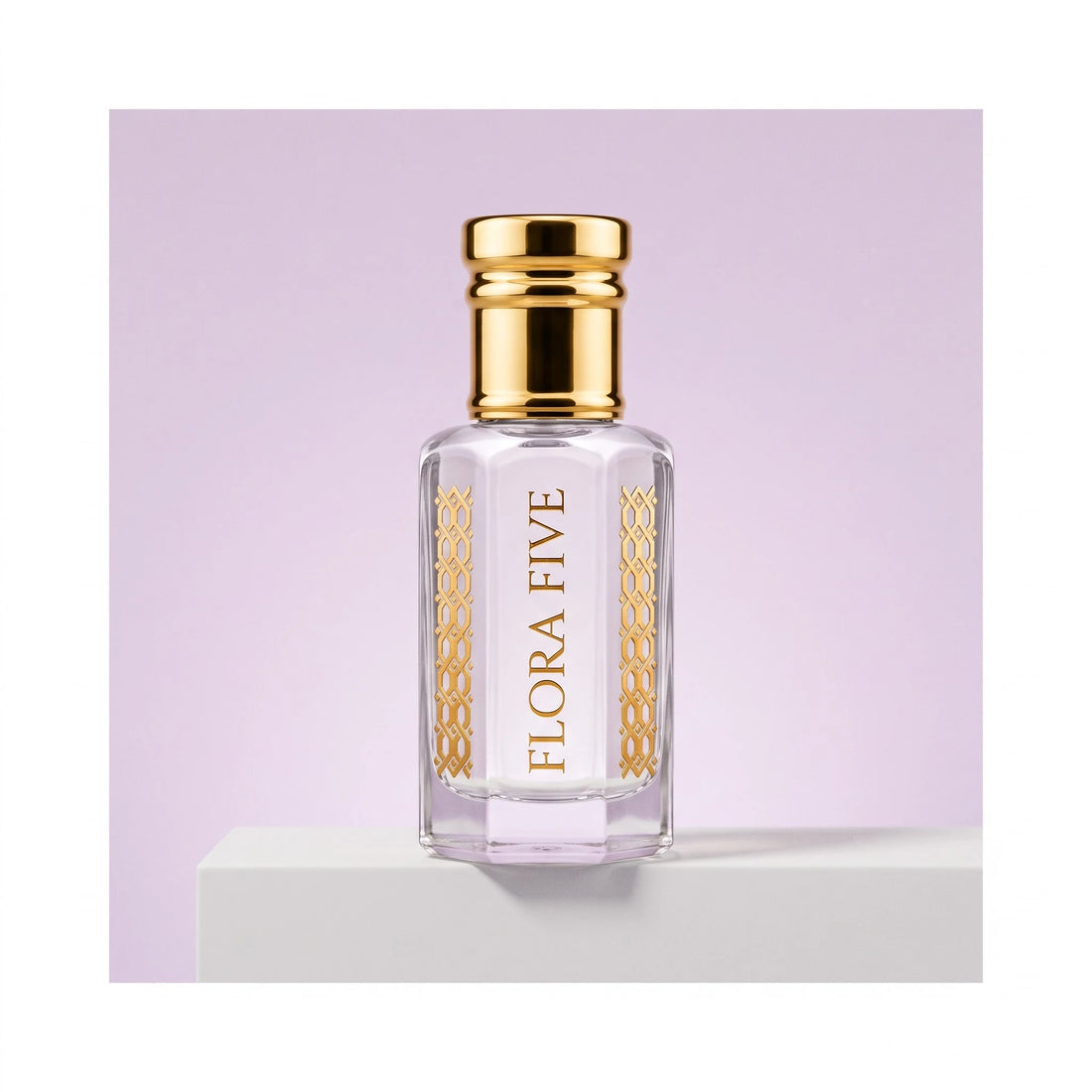 Iris Violet Attar for women — alcohol-free perfume oil by Flora Five: pale lilac oil in a gold-capped bottle on a white block against a lilac backdrop
