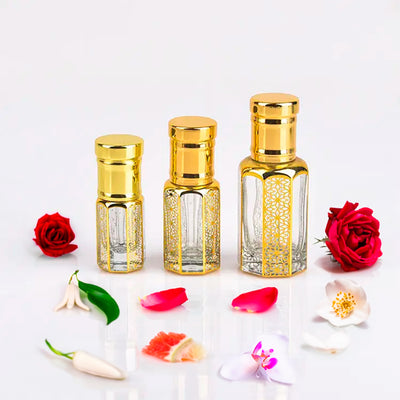 Dior J'adore inspired attar for women by Flora Five — alcohol-free perfume oil: three empty gold-capped bottles of different heights with red roses, petals and jasmine – 3, 6 and 12 ml