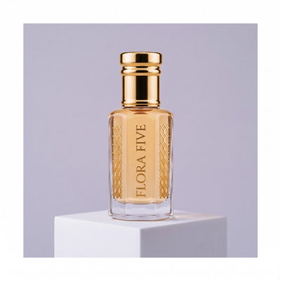 Jo Malone Myrrh & Tonka inspired attar, unisex — alcohol-free perfume oil by Flora Five: amber oil on a white plinth against a lavender-grey backdrop