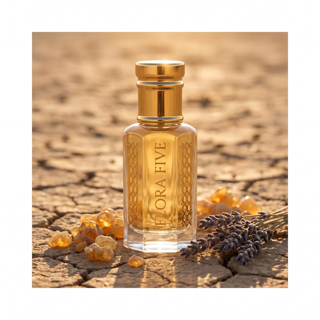 Jo Malone Myrrh & Tonka inspired attar by Flora Five — bottle on cracked desert earth with myrrh resin tears and dried lavender