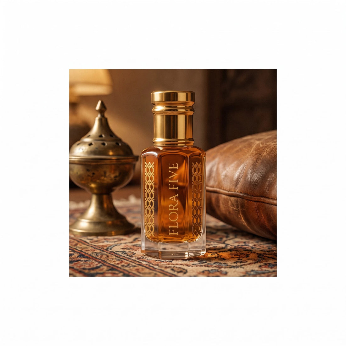 Khulasatal Oud by Flora Five — amber oud oil on a Persian rug beside a brass incense burner and a leather cushion