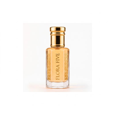 Louis Vuitton Imagination inspired attar for men — alcohol-free perfume oil by Flora Five: amber oil in a gold-capped bottle on a warm white backdrop