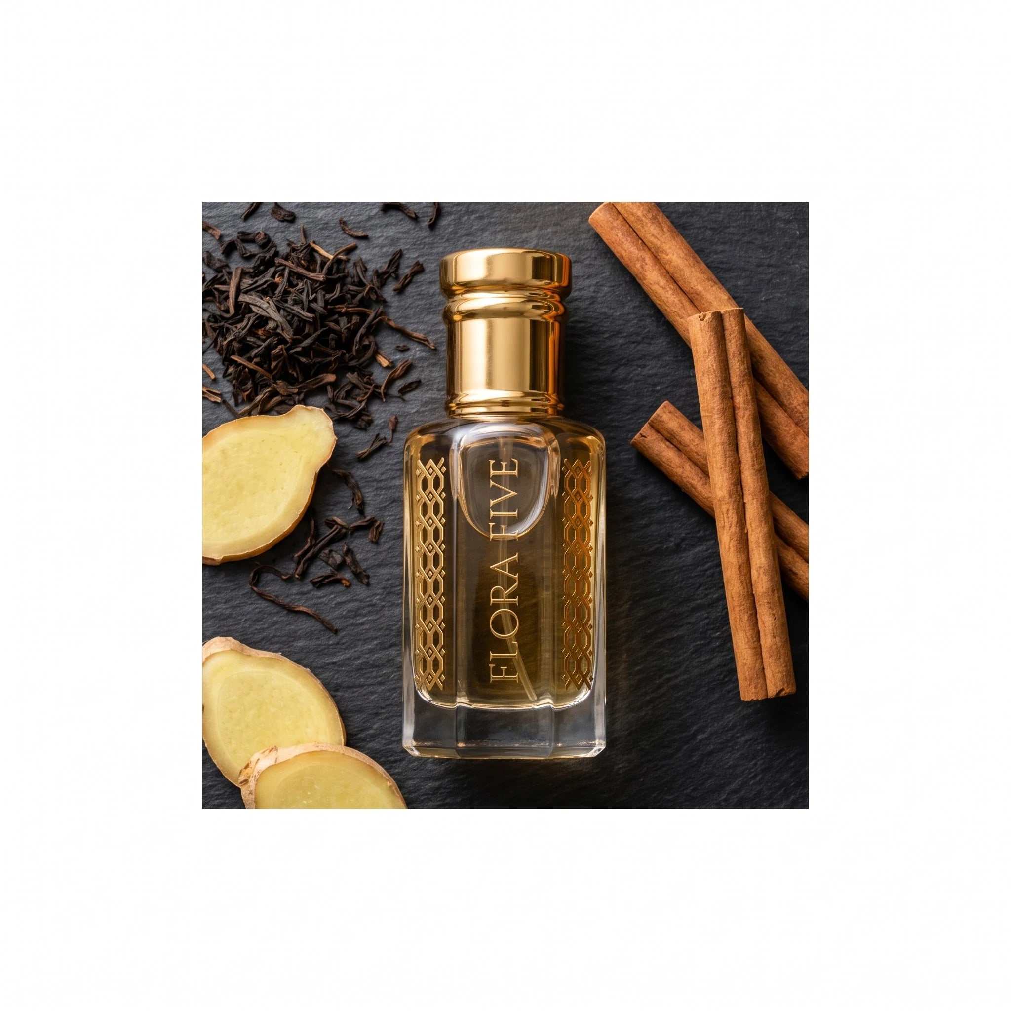 Louis Vuitton Imagination inspired attar by Flora Five — bottle on slate with black tea leaves, fresh ginger and cinnamon sticks