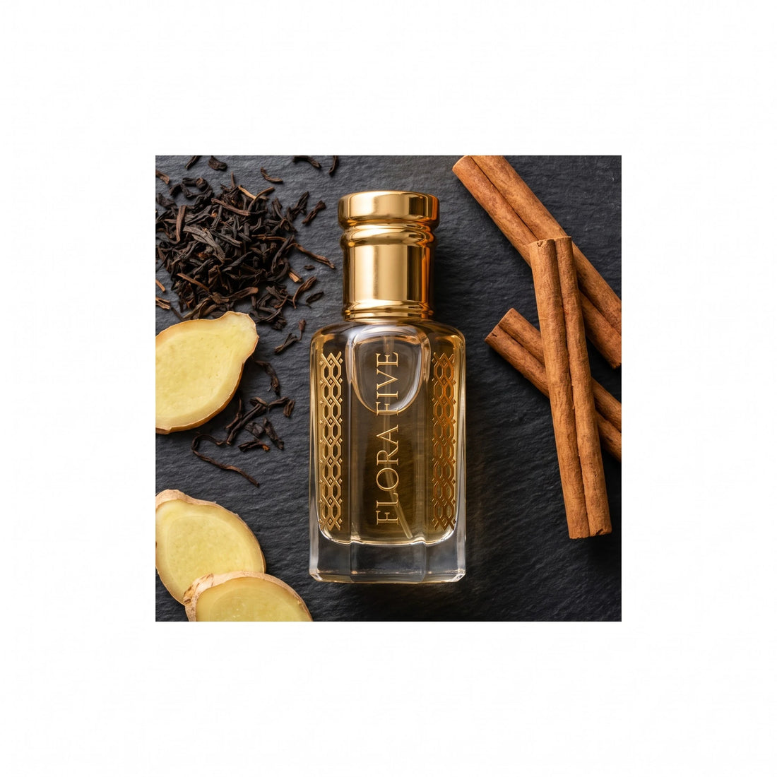 Louis Vuitton Imagination inspired attar by Flora Five — bottle on slate with black tea leaves, fresh ginger and cinnamon sticks