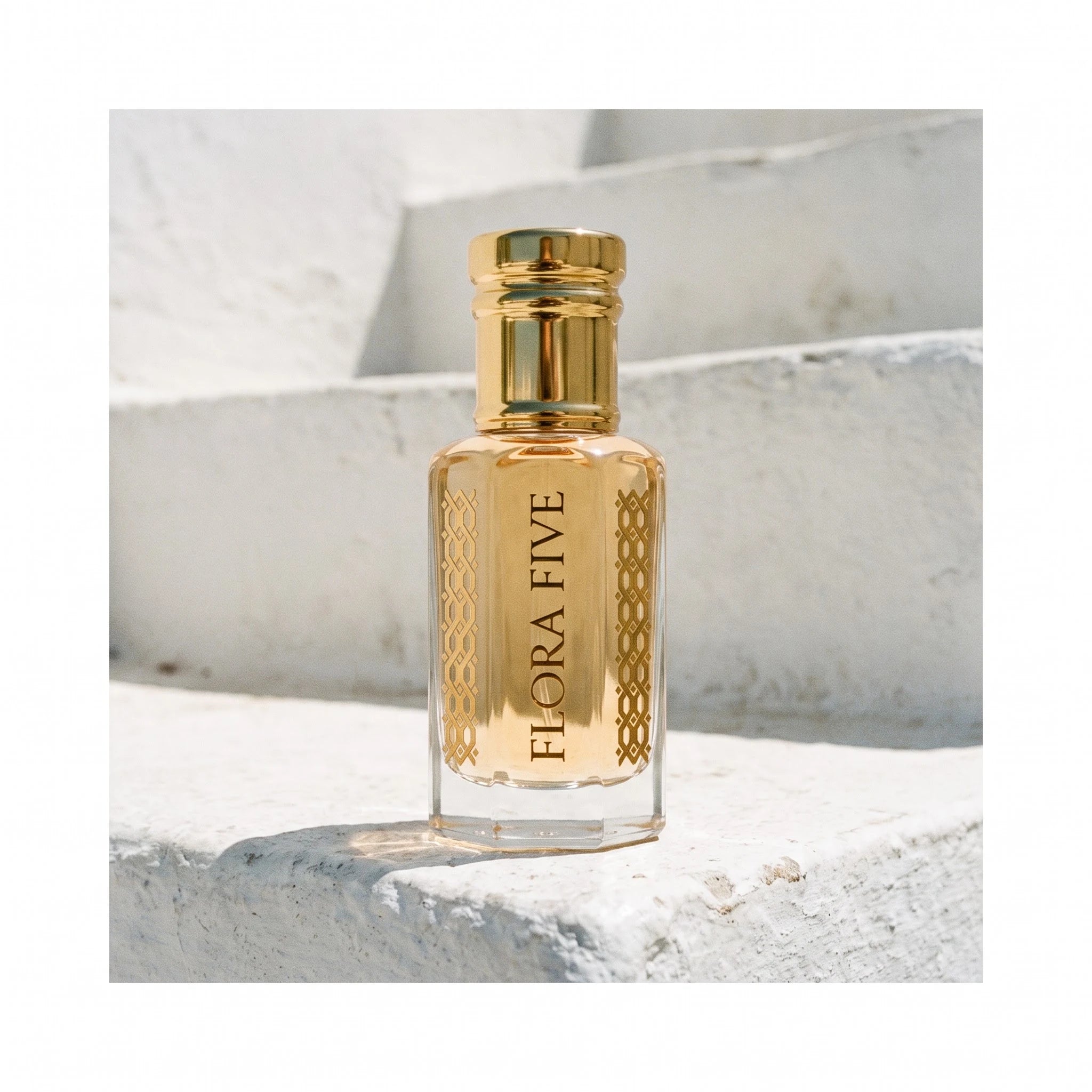 Louis Vuitton Imagination inspired attar by Flora Five — bottle on whitewashed steps in bright midday sun