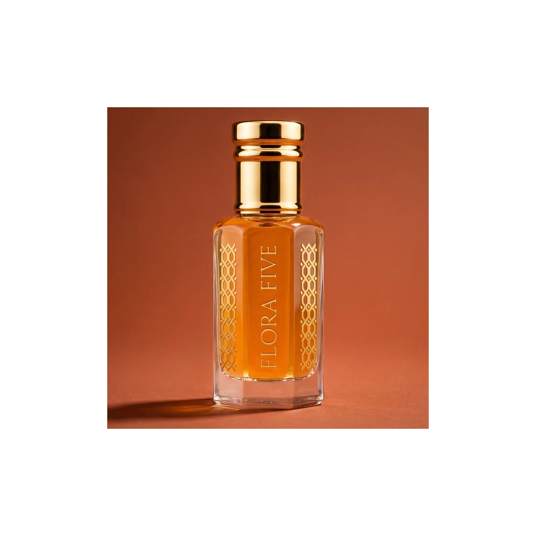 Oud Saffron unisex — alcohol-free oud oil (oudh) by Flora Five: amber oil bottle against a terracotta studio backdrop