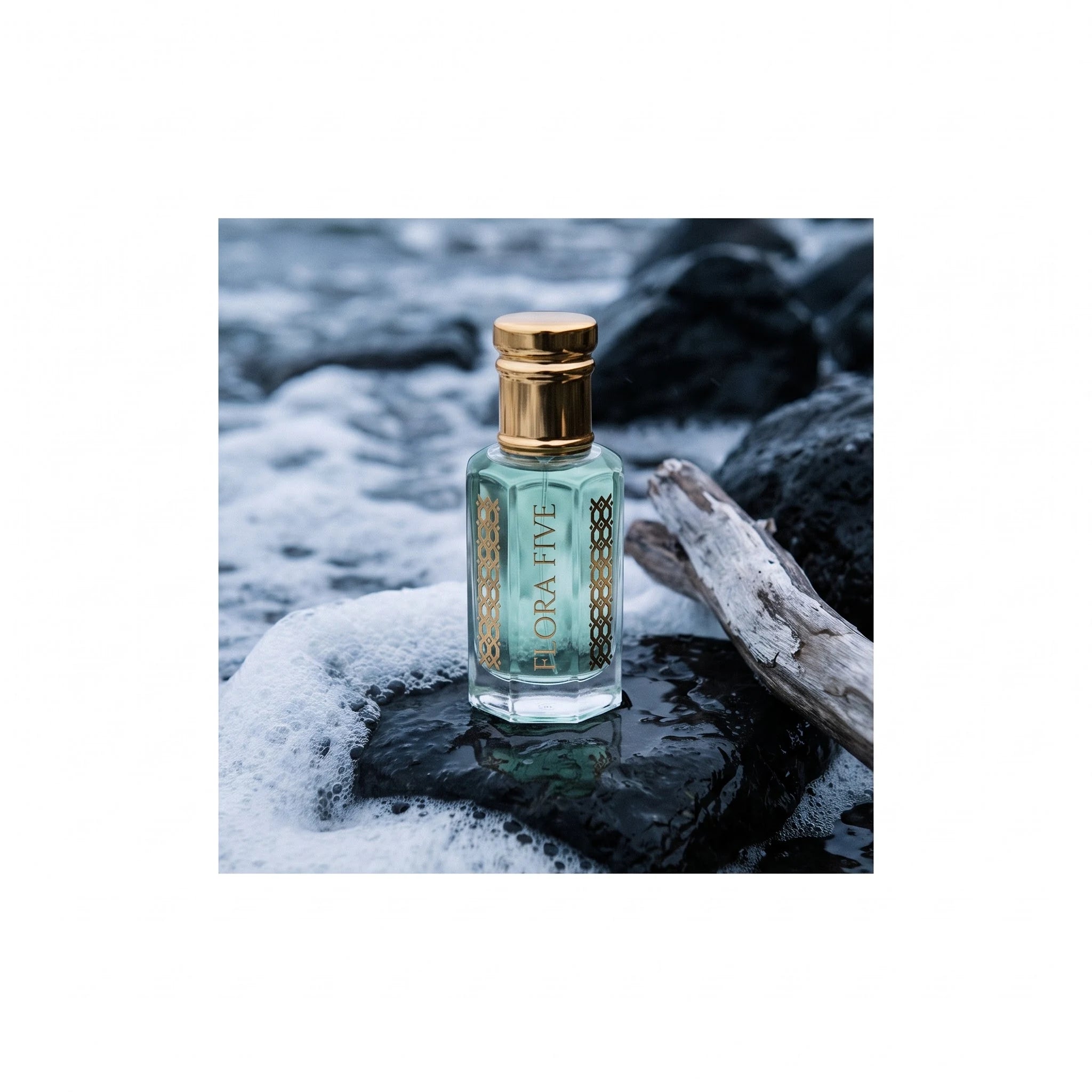 Rasasi Hawas Inspired Attar by Flora Five — aqua oil bottle on wet black rock with sea foam and driftwood
